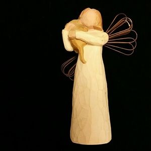 Willow Tree angel holding a puppy.